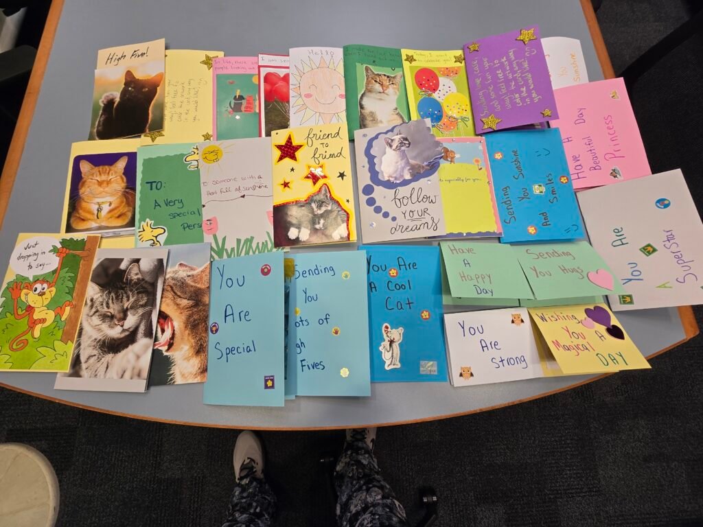 There are 28 hand-made cards on a table that will be sent to hospitalized children to cheer them up!