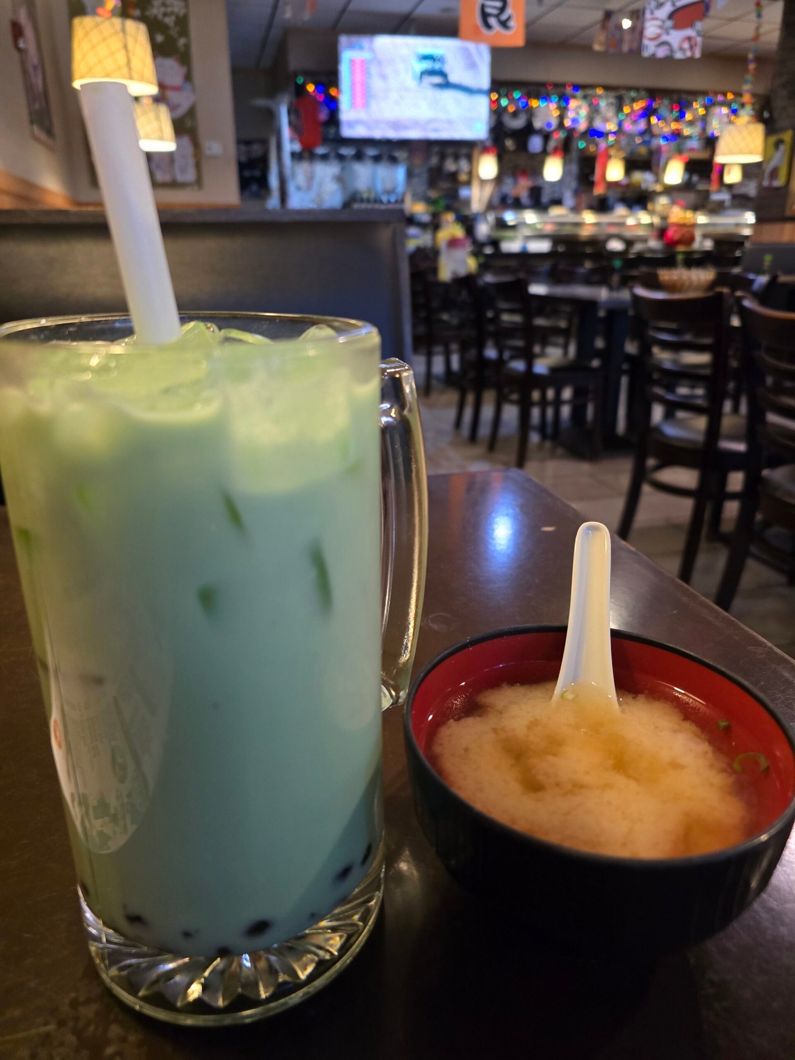 A glass of boba tea, honeydew flavor