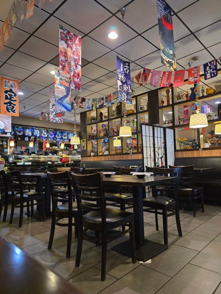 Interior of a restaurant, with lots of colorful lights and artwork